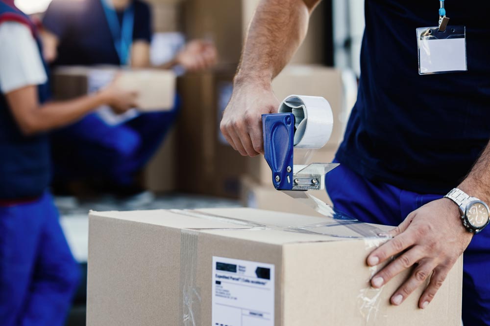 Person taping a box
